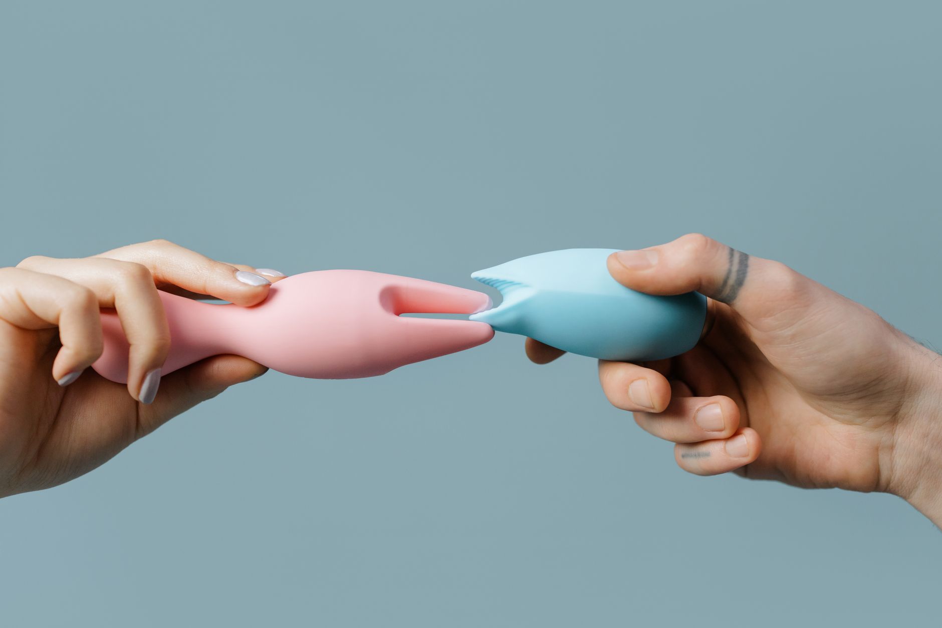 Woman holding colorful vibrators, representing diverse preferences and pleasure options for couples